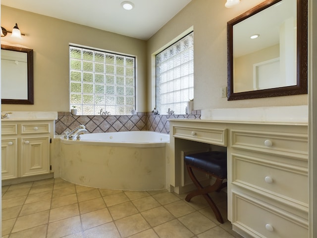 bathroom featuring vanity, a tub to relax in, and tile patterned floors