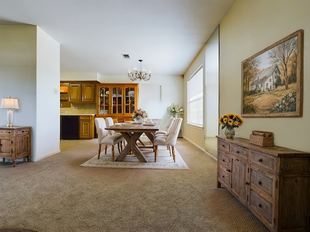 carpeted dining area with a notable chandelier