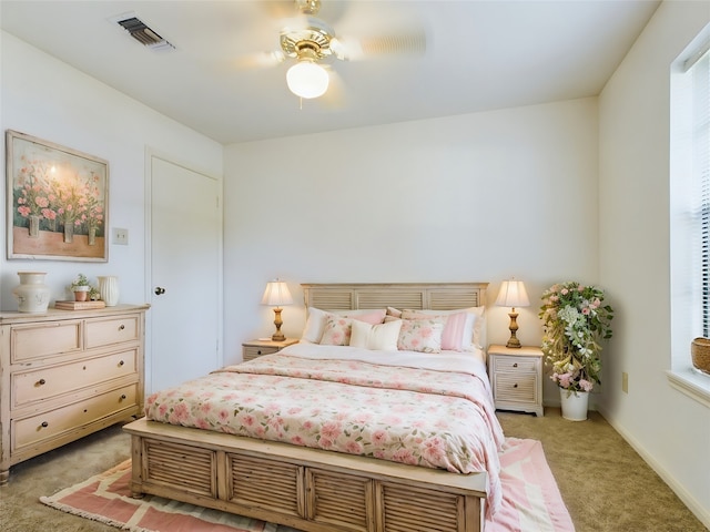 bedroom with light colored carpet and ceiling fan