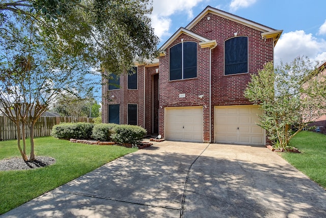 view of front property featuring a garage and a front yard