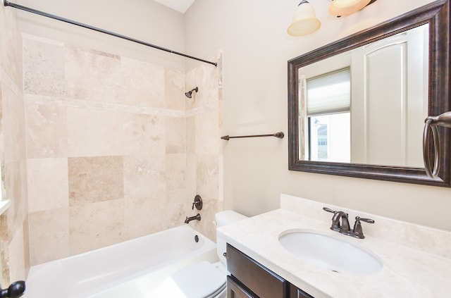 full bathroom featuring toilet, vanity, and tiled shower / bath