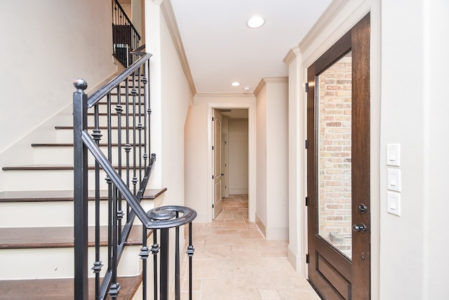 foyer featuring ornamental molding