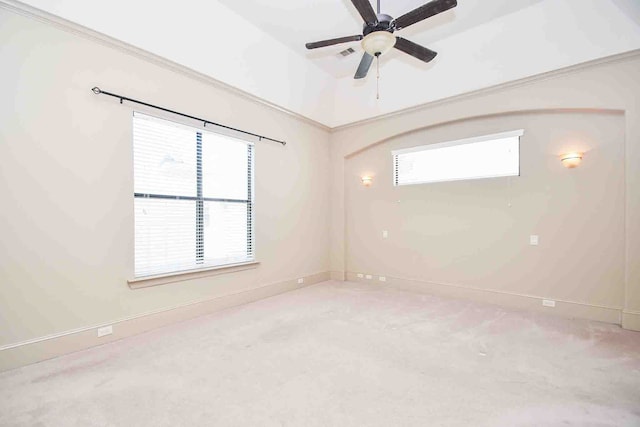 carpeted empty room with plenty of natural light and ceiling fan