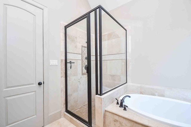 bathroom featuring shower with separate bathtub