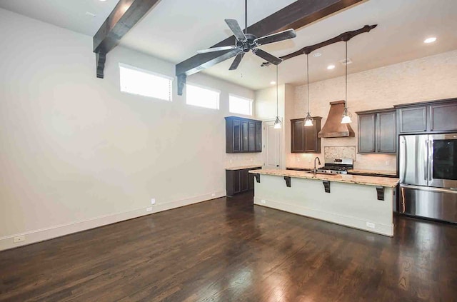 kitchen featuring a kitchen bar, dark hardwood / wood-style flooring, custom range hood, stainless steel appliances, and decorative light fixtures