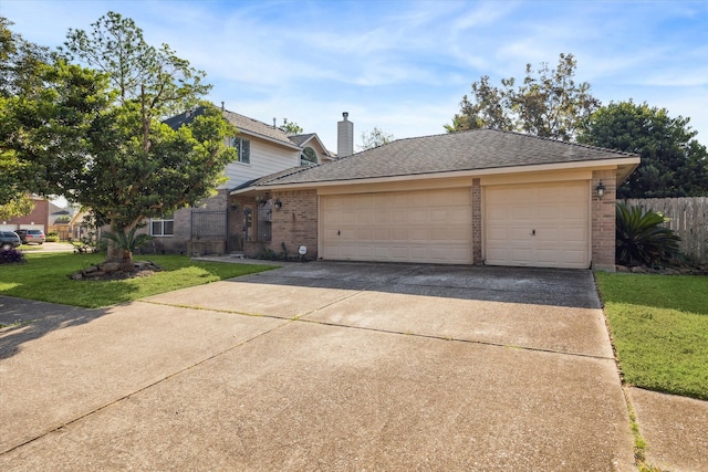 view of front facade with a front lawn and a garage