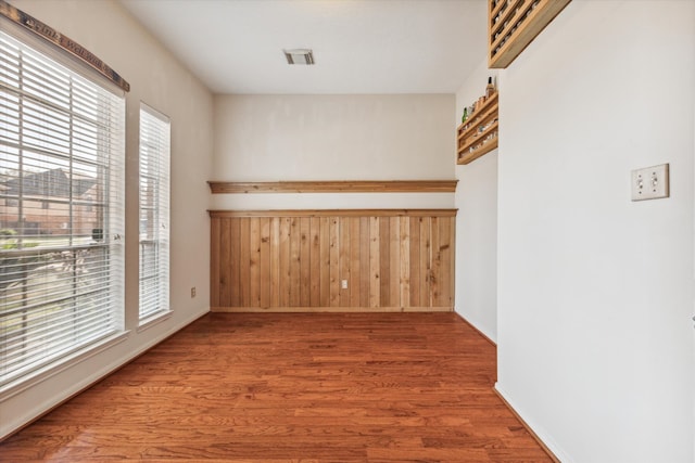 unfurnished room with hardwood / wood-style flooring