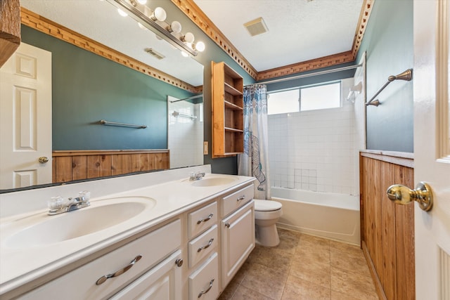 full bathroom featuring vanity, a textured ceiling, shower / bathtub combination with curtain, tile patterned floors, and toilet