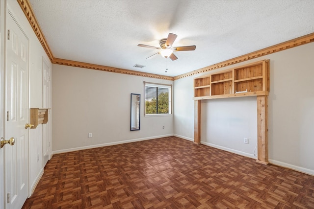 unfurnished bedroom with dark parquet floors, ceiling fan, and a textured ceiling