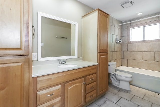 full bathroom featuring tile patterned floors, vanity, toilet, and tiled shower / bath