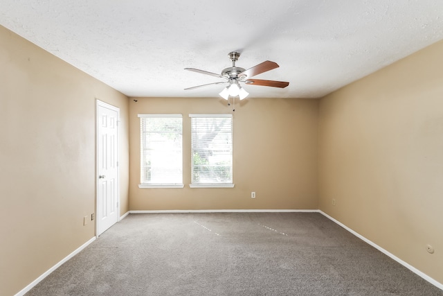 empty room with ceiling fan, carpet, and a textured ceiling