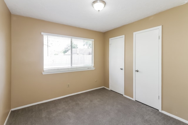 unfurnished bedroom featuring light carpet