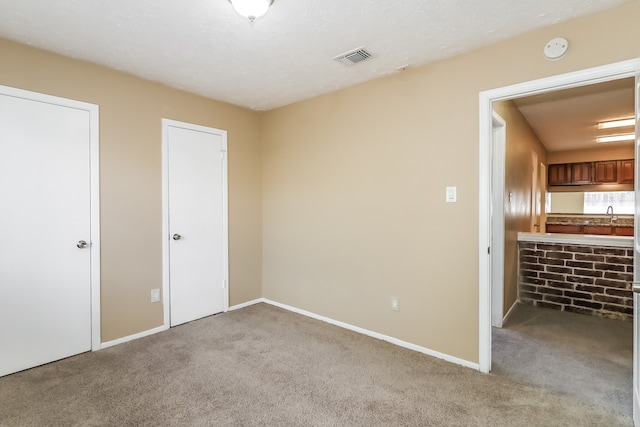 unfurnished room featuring light colored carpet