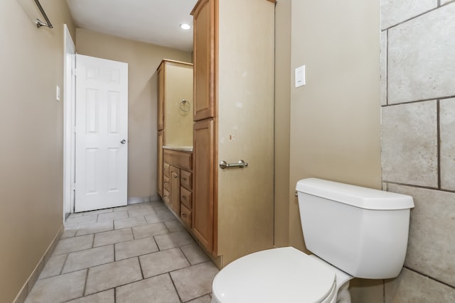 bathroom featuring tile patterned floors, vanity, and toilet