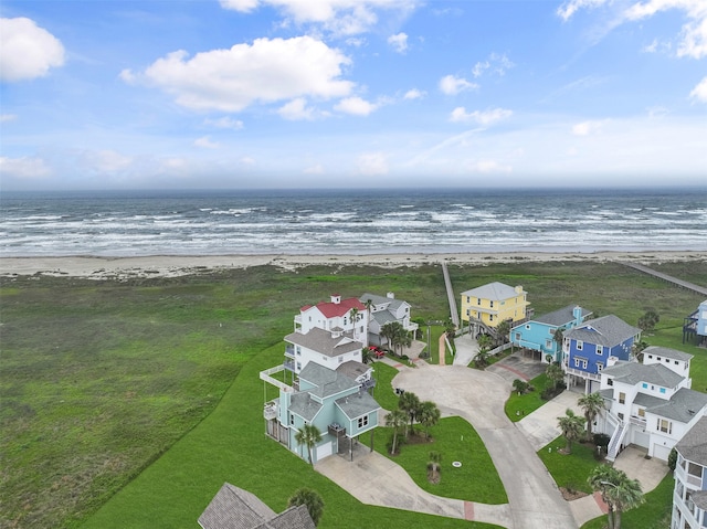 drone / aerial view with a water view and a view of the beach