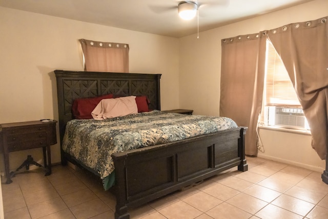 bedroom with cooling unit, light tile patterned floors, and ceiling fan