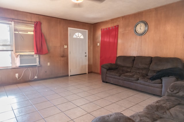 tiled living room with cooling unit, wooden walls, and ceiling fan