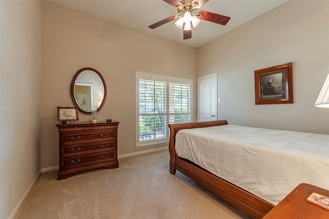 bedroom with ceiling fan and light colored carpet