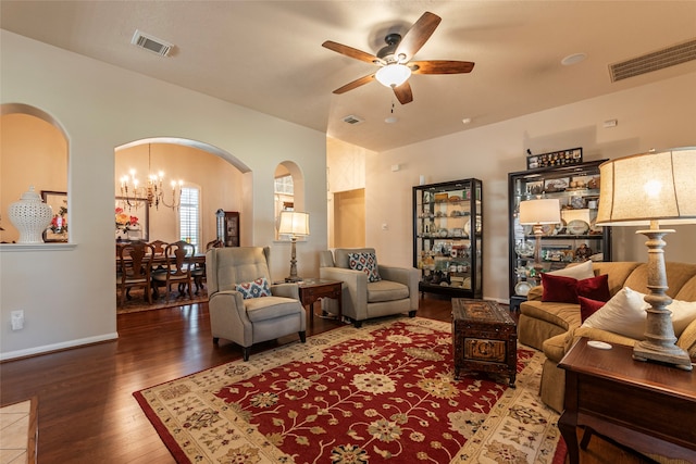 living room with ceiling fan with notable chandelier and hardwood / wood-style floors