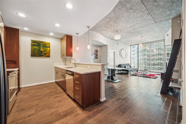 kitchen with sink, appliances with stainless steel finishes, pendant lighting, and dark hardwood / wood-style flooring