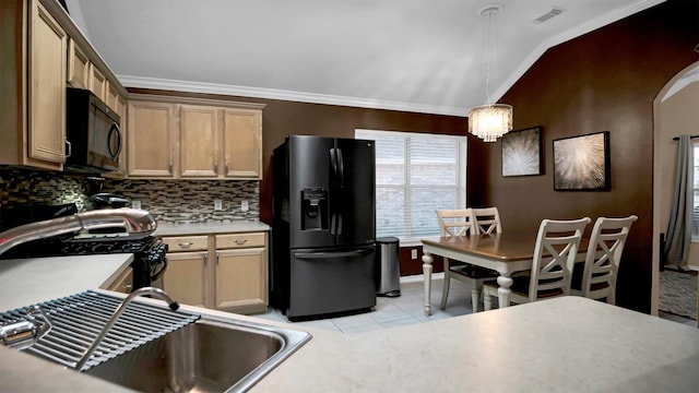 kitchen with pendant lighting, sink, lofted ceiling, black appliances, and light tile patterned floors