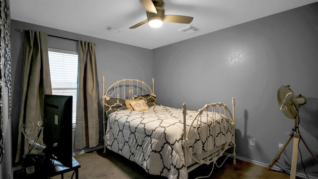 bedroom with ceiling fan and dark carpet