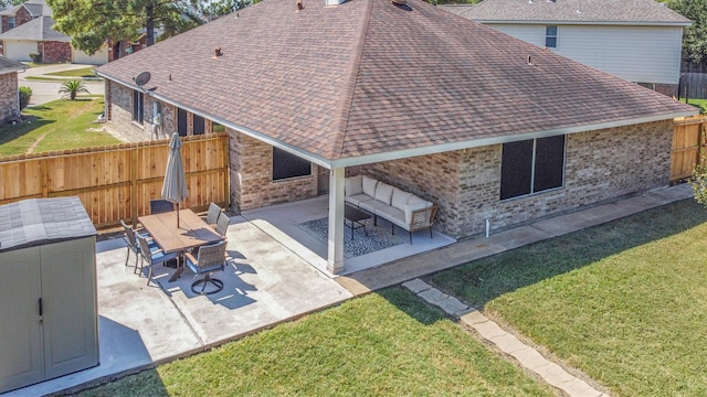 rear view of house featuring a patio and a lawn