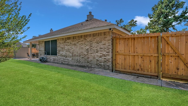 back of house with a yard and a patio area