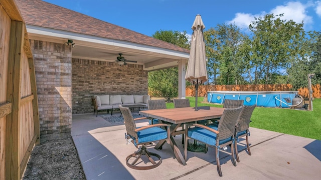 view of patio featuring ceiling fan and a fenced in pool