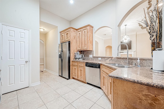 kitchen featuring sink, light tile patterned floors, tasteful backsplash, stone countertops, and stainless steel appliances