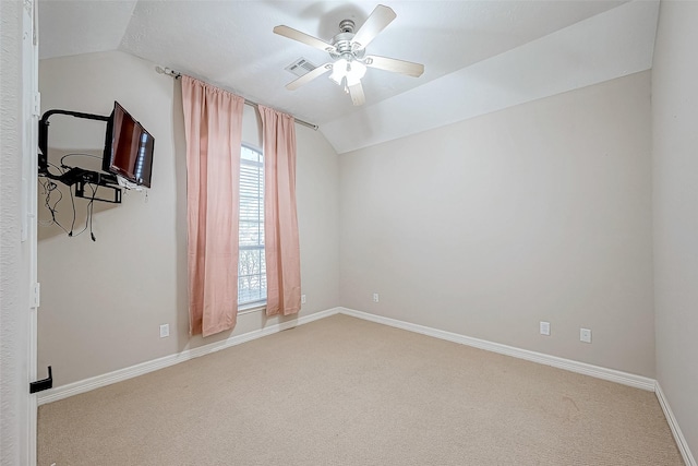 carpeted empty room with vaulted ceiling and ceiling fan