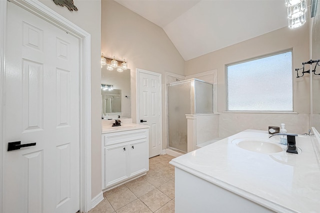 bathroom featuring tile patterned flooring, vanity, lofted ceiling, and walk in shower