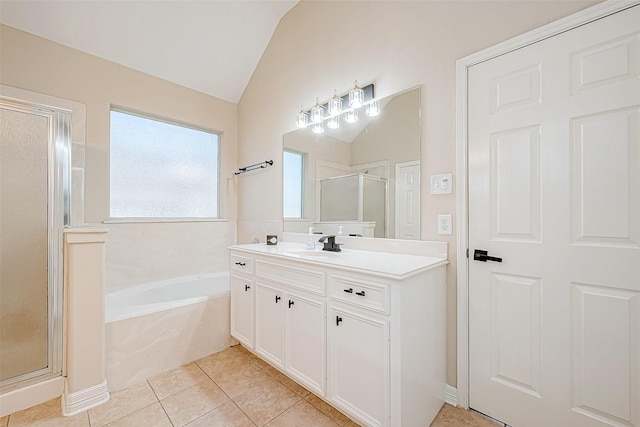 bathroom with tile patterned floors, vanity, independent shower and bath, and lofted ceiling