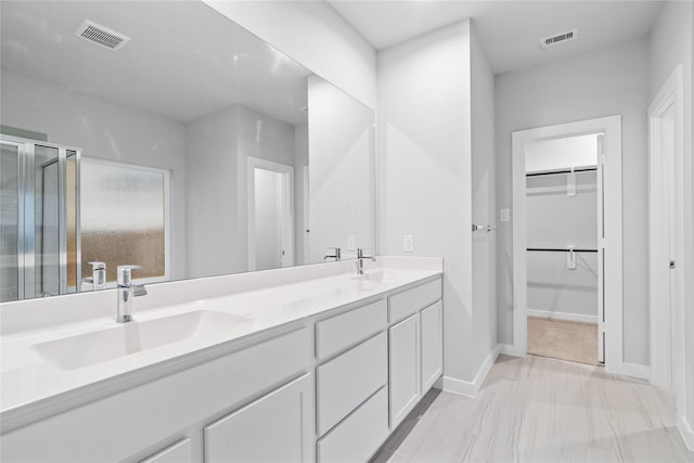 bathroom featuring vanity and an enclosed shower