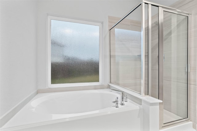 bathroom with separate shower and tub