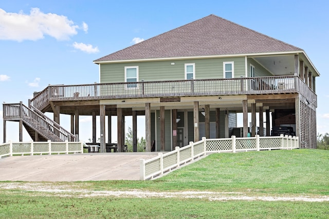 back of property with a wooden deck and a yard