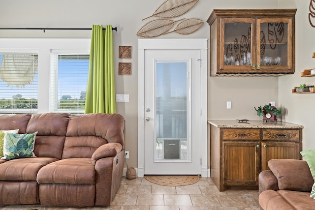 doorway to outside with light tile patterned flooring