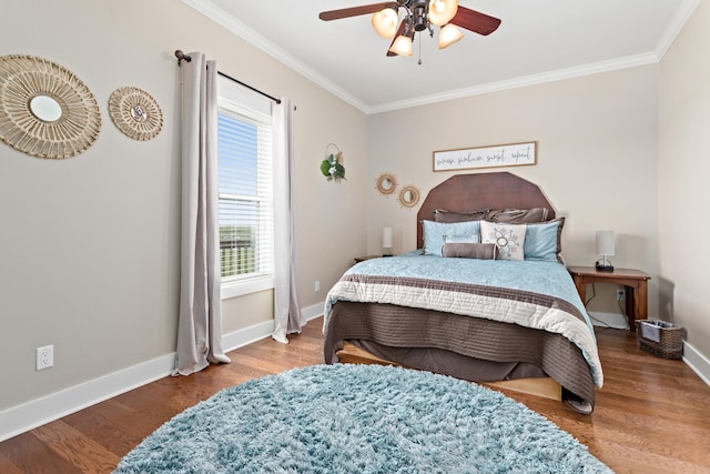 bedroom with ornamental molding, hardwood / wood-style flooring, and ceiling fan