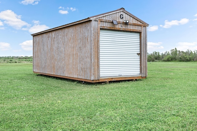 view of outdoor structure featuring a lawn