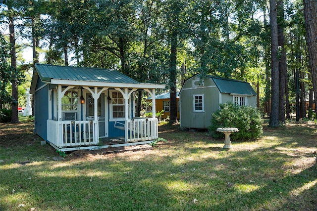 exterior space with a porch and an outbuilding