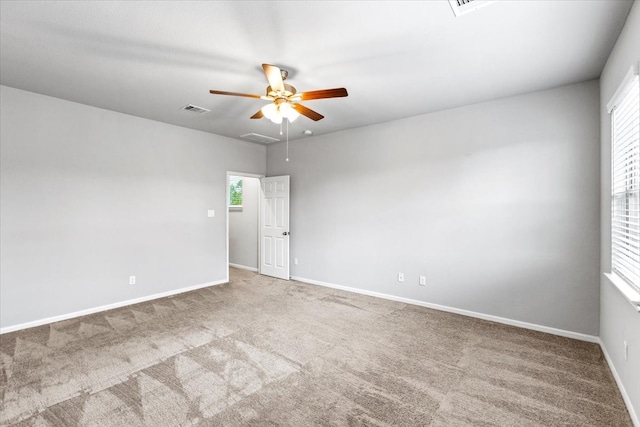 carpeted empty room featuring ceiling fan