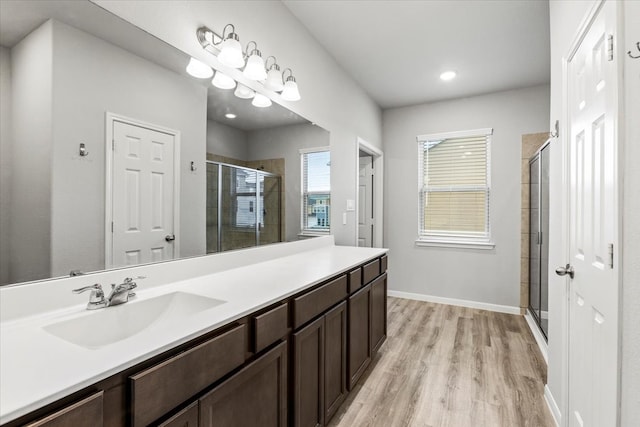 bathroom featuring hardwood / wood-style floors, vanity, and walk in shower