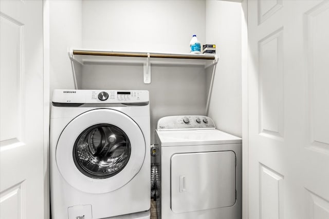 clothes washing area featuring washing machine and clothes dryer