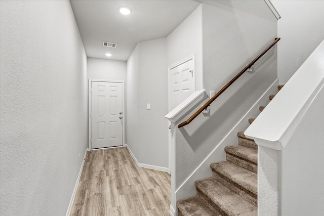 stairs with wood-type flooring