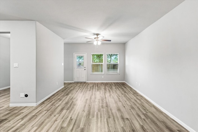 unfurnished living room featuring ceiling fan and light wood-type flooring