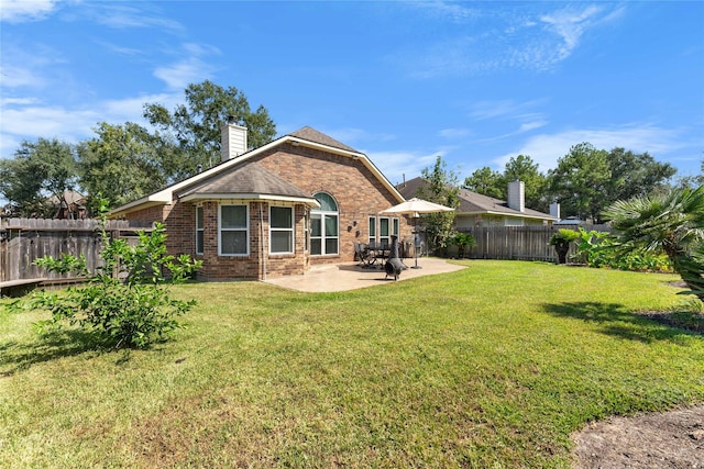 back of house with a patio and a lawn