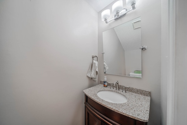 bathroom with vanity and a textured ceiling