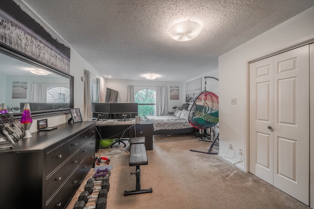 bedroom with a textured ceiling and carpet flooring