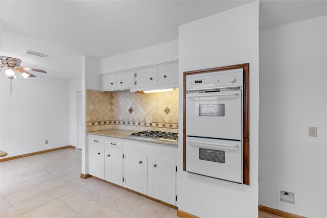 4415 Fallbrook Dr, Houston, TX 77018 - kitchen featuring gas stovetop, double oven, tasteful backsplash, baseboards, and white cabinetry