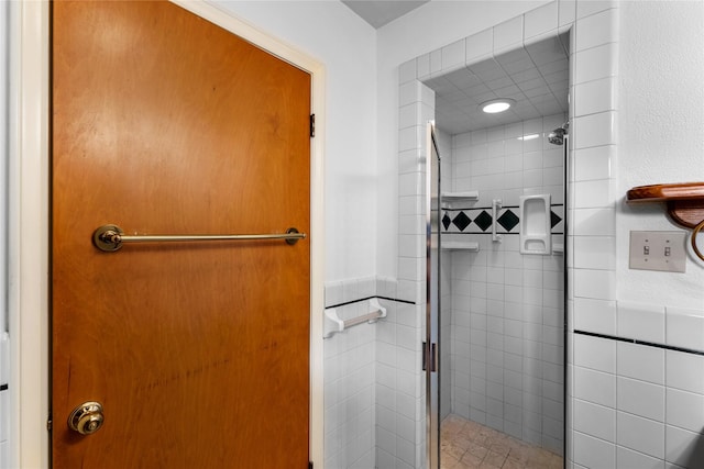 4415 Fallbrook Dr, Houston, TX 77018 - bathroom featuring a stall shower, tile walls, and a wainscoted wall